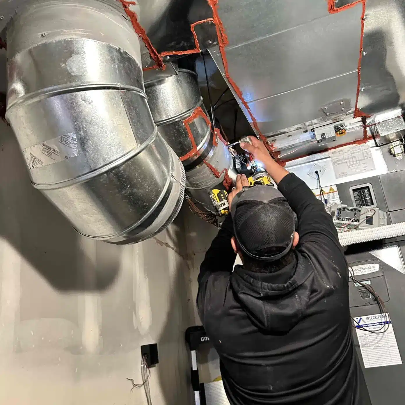 Thermostat being adjusted to regulate the furnace temperature